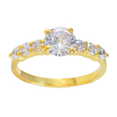 Dewi white gemstone gold ring featuring a large center stone with smaller gemstones on gold band