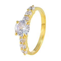 Dewi white gemstone gold ring with multiple round white gemstones set on a polished gold band