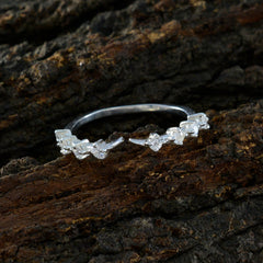 Riya white gemstone ring for women with delicate silver band and sparkling stones on textured wood background