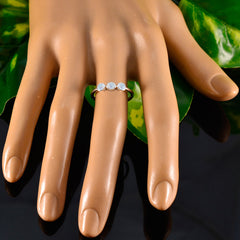 Ling white gemstone ring for women with three round white stones on silver band displayed on mannequin hand