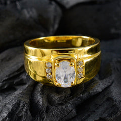 Nisa gold ring with large central gemstone and side diamonds, not a white halo engagement ring