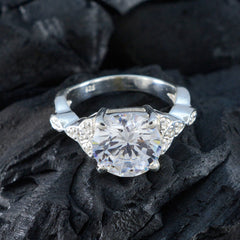 Nova white halo ring for women with a large round center stone and smaller accent diamonds on silver band