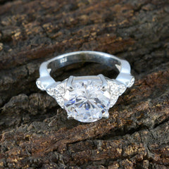 Nova white halo ring for women with a large round center stone and smaller side stones on silver band