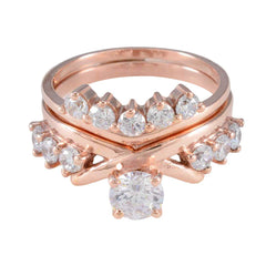 Elena rose gold ring set with center solitaire and white multiple stone engagement ring design