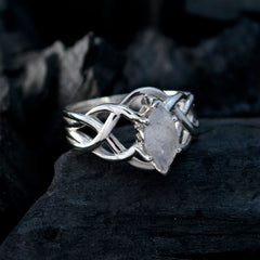 Charlotte white solitaire art deco ring with marquise stone and twisted silver band on dark background