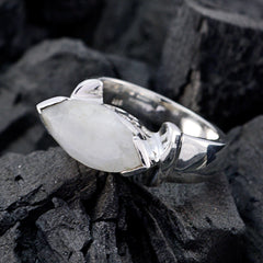 Bruna white solitaire filigree ring with a marquise gemstone set in silver band on dark textured background