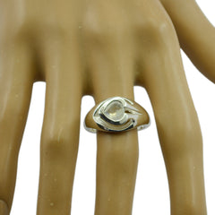 Leah white solitaire ring with a unique heart-shaped design on a display hand