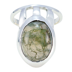 Andrea white solitaire signet ring featuring a polished silver band with an oval green gemstone centerpiece