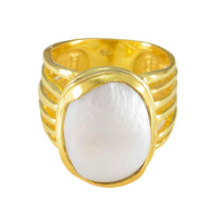 Eleanor gold band white solitaire statement ring with a large oval white stone centerpiece