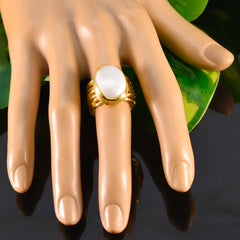 Eleanor gold ring with white solitaire statement ring featuring a large oval stone on display hand