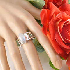 Chloe white solitaire statement ring with a marquise gemstone on a display hand with red roses