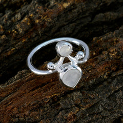 Priya elegant white toi et moi ring with two stones on silver band on rustic wood background
