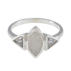 Lucy white trilogy ring featuring a marquise center stone with two triangular side stones in silver band