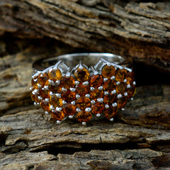 Valentina yellow gemstone cocktail ring cluster of round golden yellow stones in silver band on wood