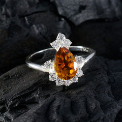 Lakshmi yellow gemstone halo ring featuring a pear-shaped yellow stone surrounded by clear crystals on a silver band
