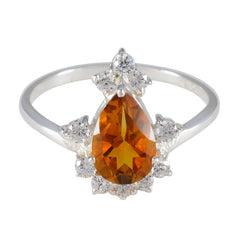 Lakshmi yellow gemstone halo ring with pear-shaped yellow center stone and surrounding clear accents