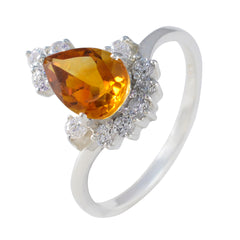 Lakshmi yellow gemstone halo ring with pear-shaped center stone and surrounding diamonds on silver band