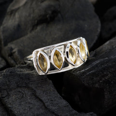 Natalie yellow gemstone ring with marquise cut stones set in silver band on dark textured background