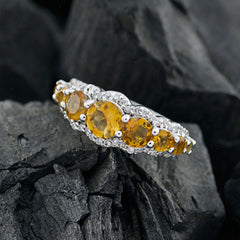 Putri yellow gemstone ring with five round yellow stones and pave diamond halo on sterling silver band