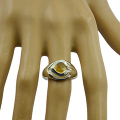 Lea yellow gemstone solitaire ring with gold band displayed on a mannequin hand