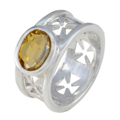 Emily yellow gemstone solitaire ring with intricate silver band and oval yellow stone