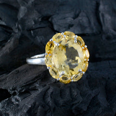 Lili yellow gemstone statement ring with silver band on a textured black surface