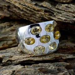 Dewi yellow gemstone statement ring with multiple oval yellow stones set in wide silver band