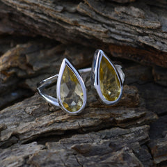 Riya yellow gemstone toi et moi ring with pear-shaped yellow stones set in silver band on rustic wood