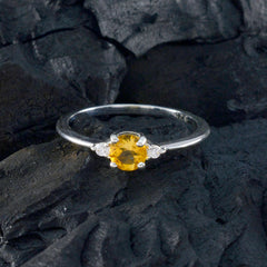 Xiu yellow gemstone trilogy ring with a round yellow center stone and two smaller clear side stones