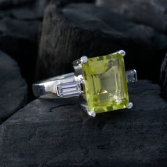 Mila yellow gemstone trilogy ring with rectangular yellow center stone and side baguette accents