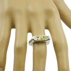 Siti yellow gemstone trilogy ring with three yellow stones set in a silver band on a hand model