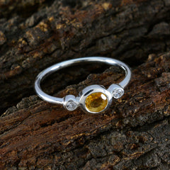 Dewi yellow gemstone trilogy ring with a central yellow stone and two small clear stones on silver band