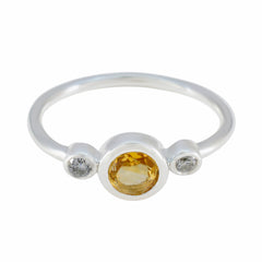 Dewi yellow gemstone trilogy ring with a central yellow gemstone and two smaller clear stones on a silver band