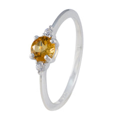 Xiu yellow gemstone trilogy ring with a round yellow center stone and two small clear side stones