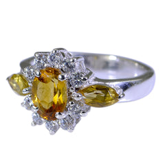 Dewi yellow gemstone trilogy ring with oval center stone and diamond accents on silver band