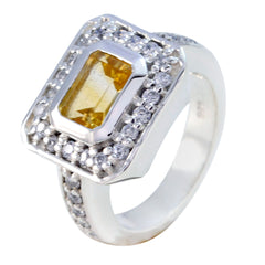 Elena yellow halo ring for women with emerald cut yellow center stone, clear stone halo and pave set stones on silver band