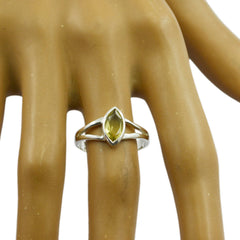 Bianca yellow solitaire ring with marquise-cut yellow gemstone on silver band displayed on mannequin hand