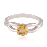 Violet yellow solitaire ring with a round yellow gemstone set in a silver twisted band