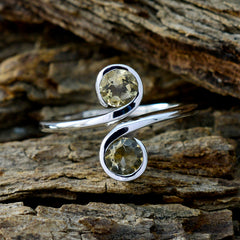 Laura yellow toi et moi ring sterling silver open swirl design with two bezel set yellow gemstones on rustic wood