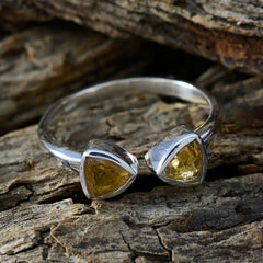 Julia sterling silver yellow toi et moi ring with two triangular yellow gemstones on wood