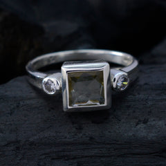 Nisa silver ring featuring a square yellow centerpiece with two small clear stones yellow trilogy ring
