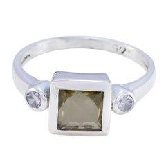 Nisa silver ring featuring a square yellow gemstone and two smaller clear stones yellow trilogy ring
