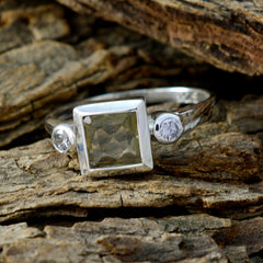 Nisa yellow trilogy ring with square yellow center stone and two round clear side stones on silver band