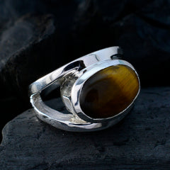 Eva artisan brown solitaire ring with polished silver band and oval brown stone