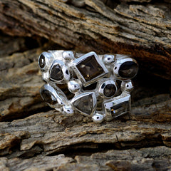 Chloe abstract brown gemstone ring with multiple shaped stones set in silver band on rustic wood