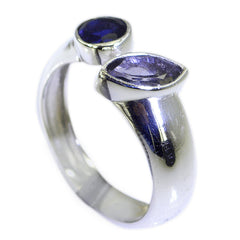 Jia blue gemstone toi et moi ring with two differently shaped blue stones set on a polished silver band
