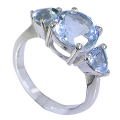 Chloe blue gemstone trilogy ring with three light blue stones set in a silver band