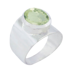 Angel light green solitaire ring with a wide silver band and oval gemstone centerpiece