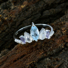 Dewi multicolor gemstone penta ring with marquise and oval stones set on silver band on textured wood