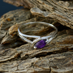 Hua purple solitaire ring for women with marquise cut gemstone set in silver band on wood